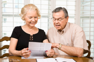 Mature Caucasian couple looking at their financial documents